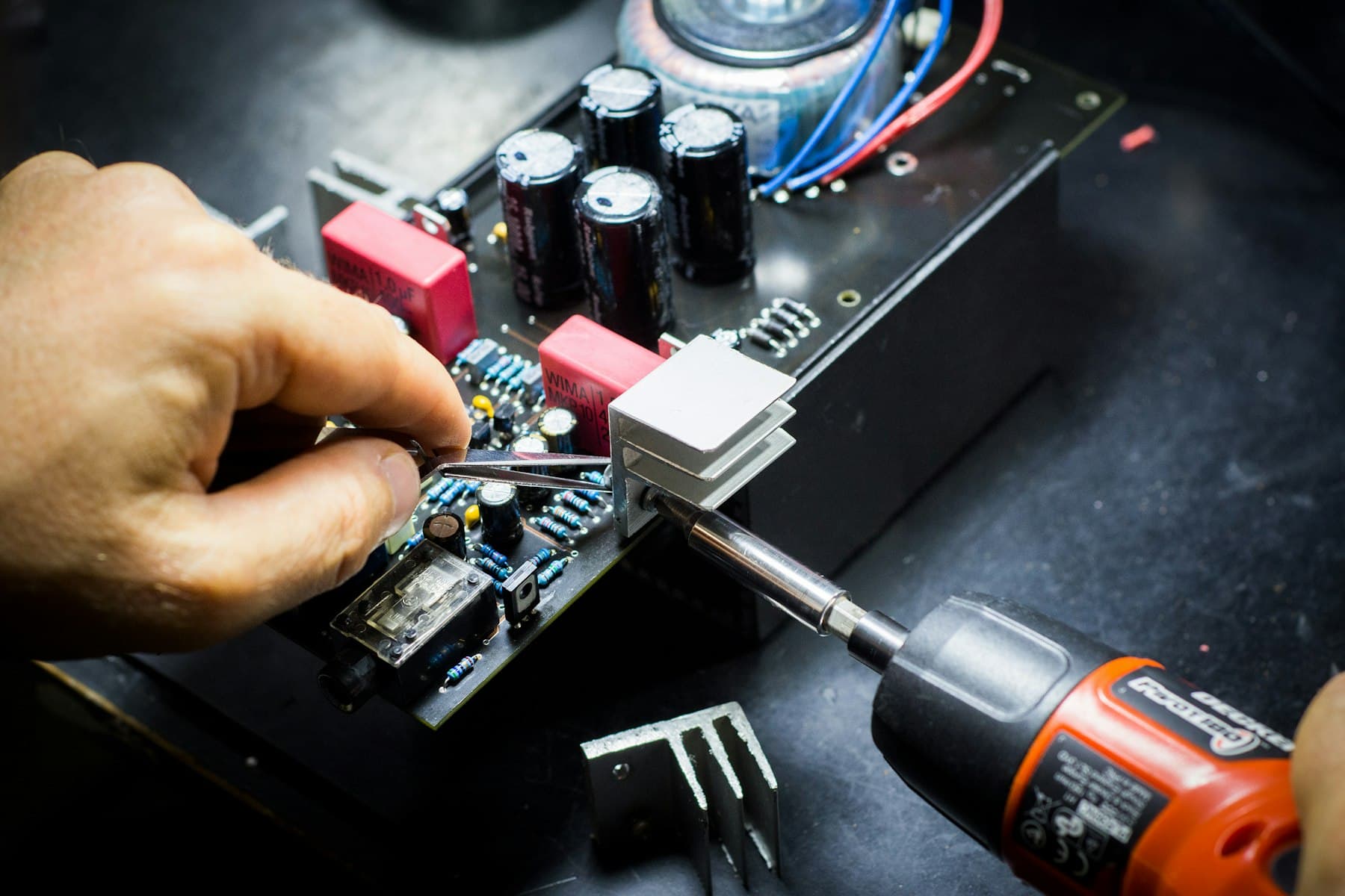 A black circuit board photographed against a black background.